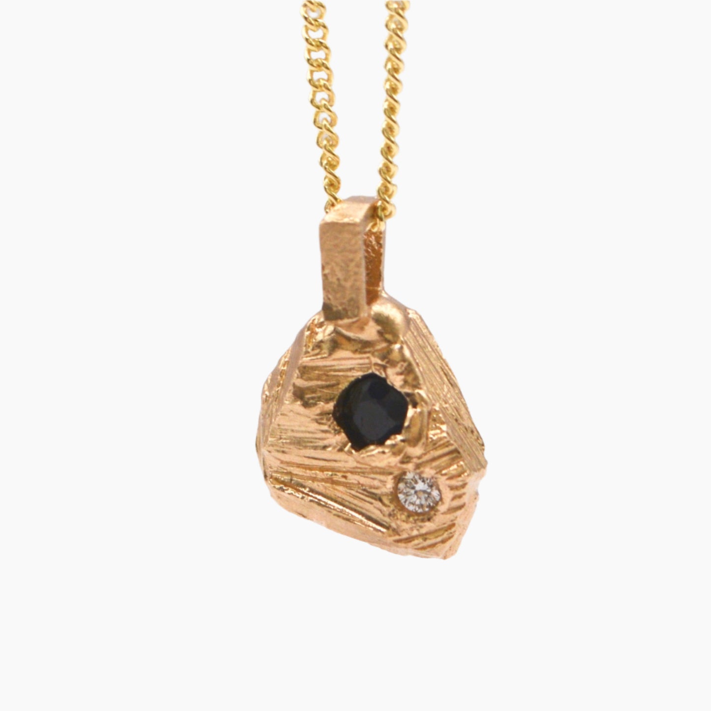 solid gold textured rok pendant featuring precious stones