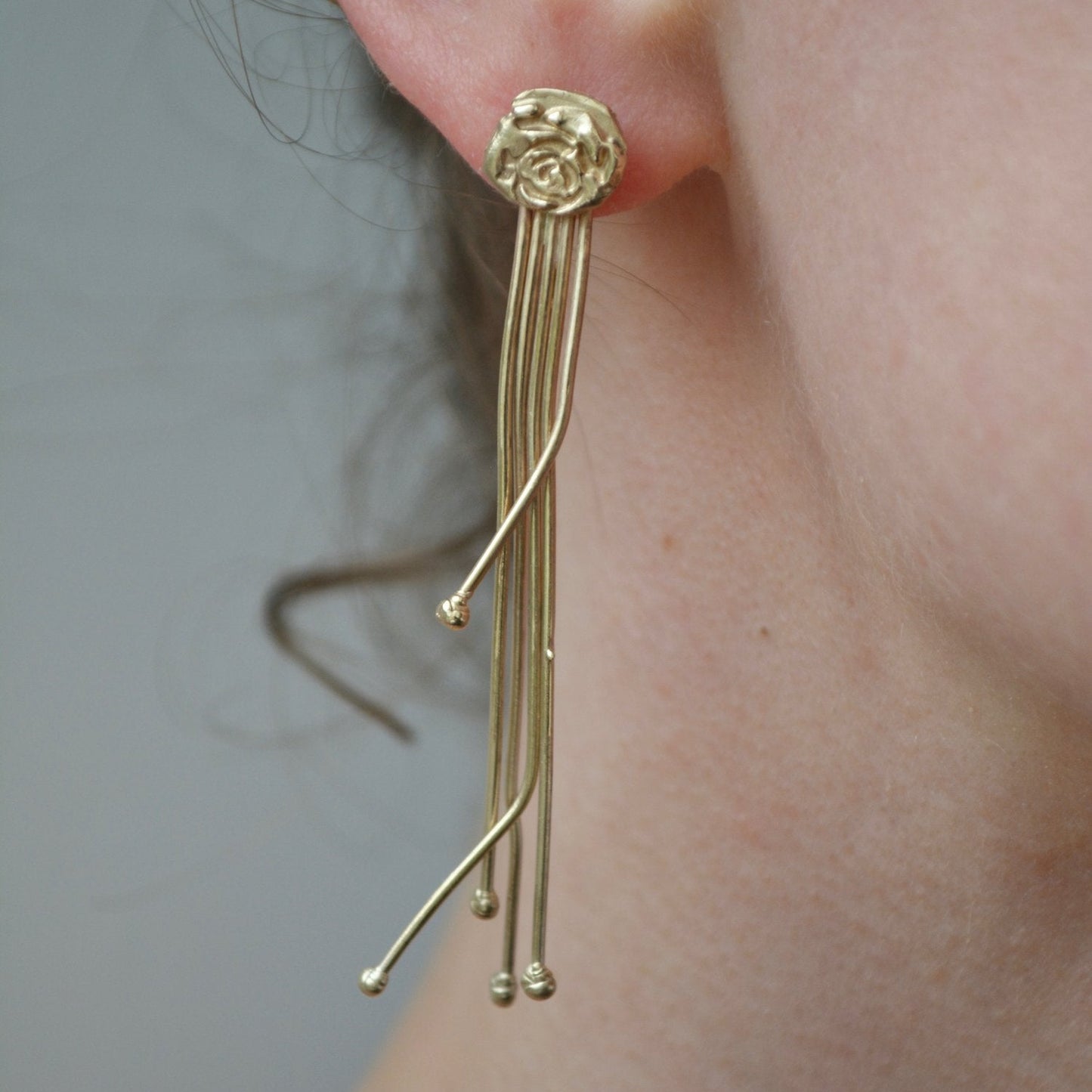 rose drop statement earrings pictured om models ear.