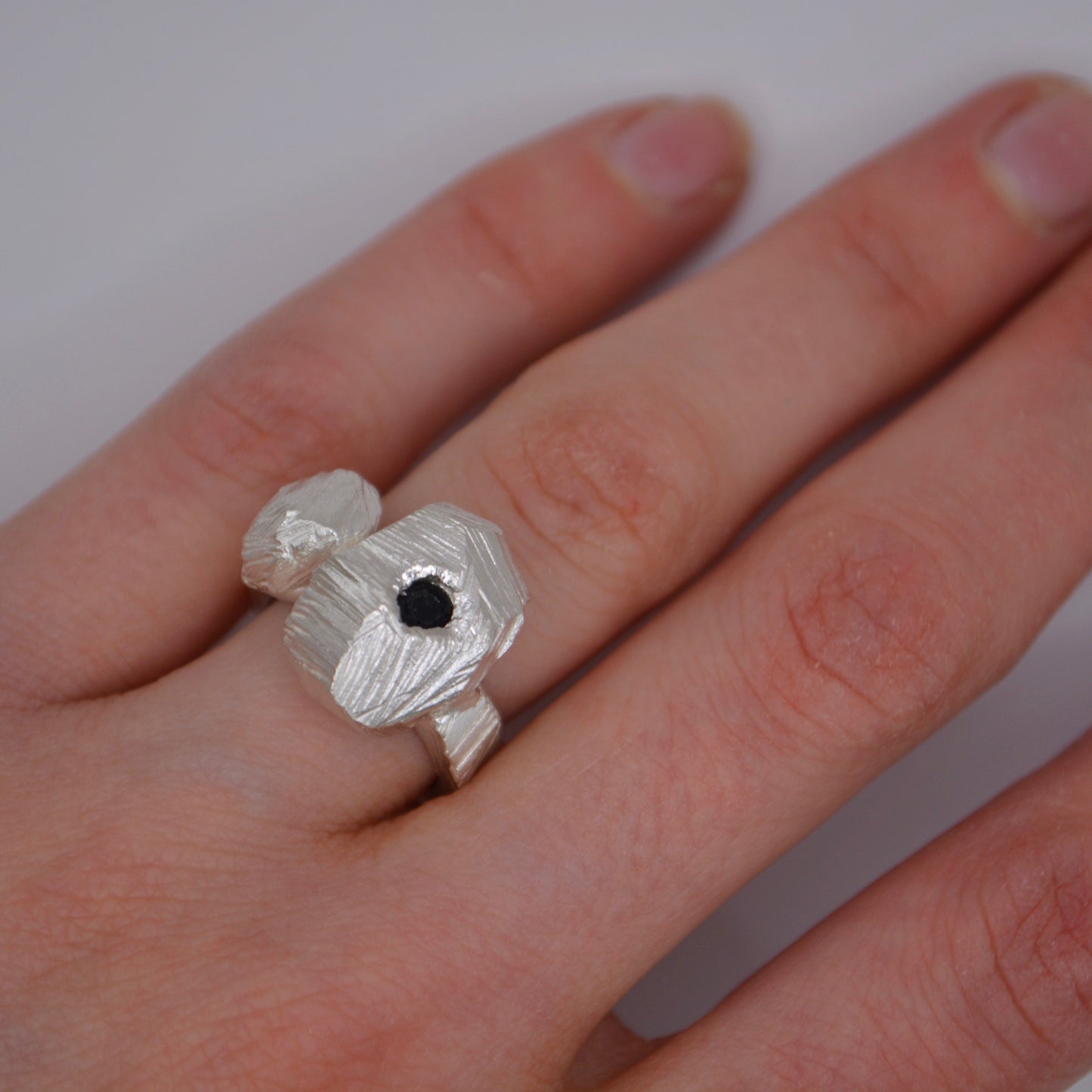 Sterling Silver rock formation statement ring featuring a midnight sapphire