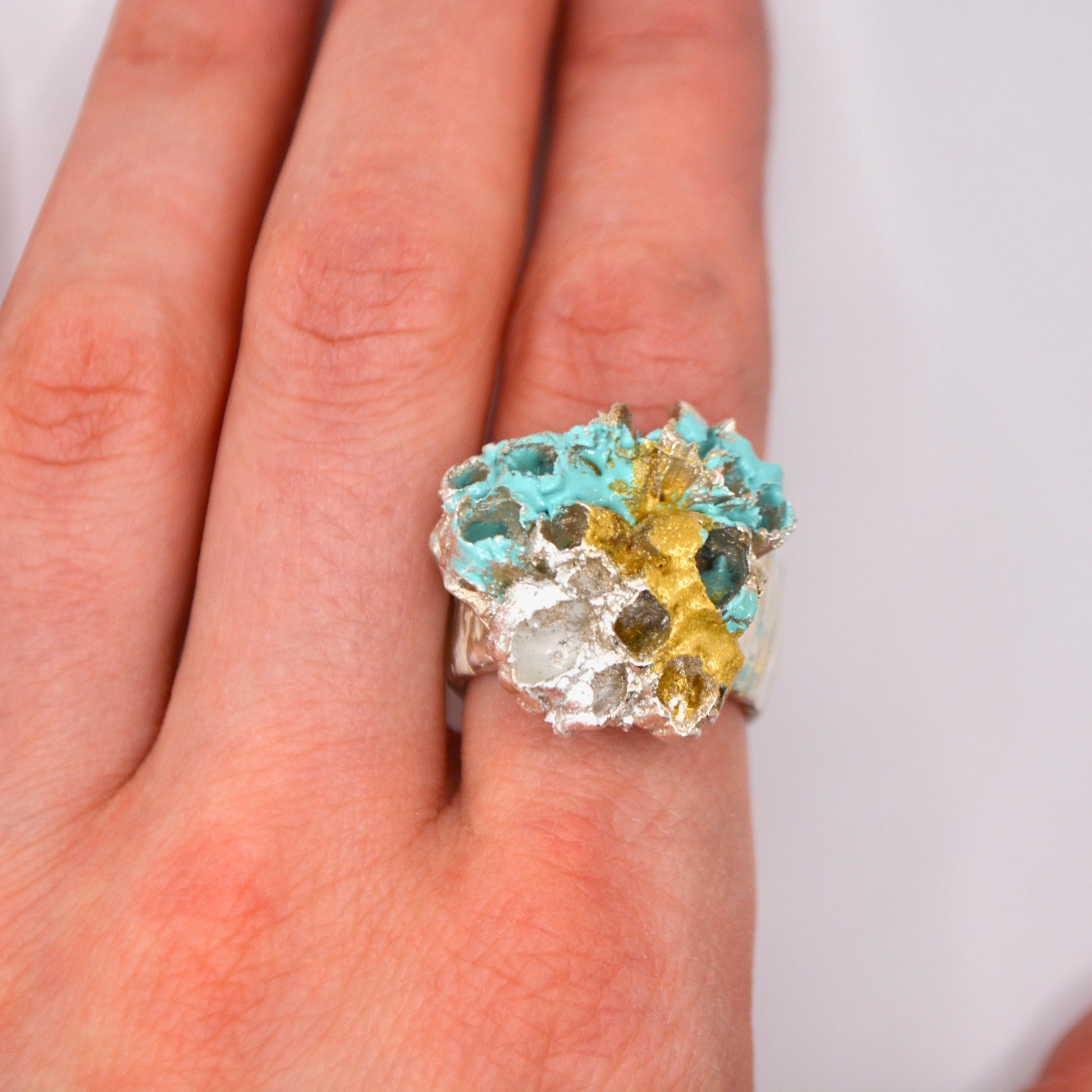 A sterling Silver and enamel statement ring on a hand