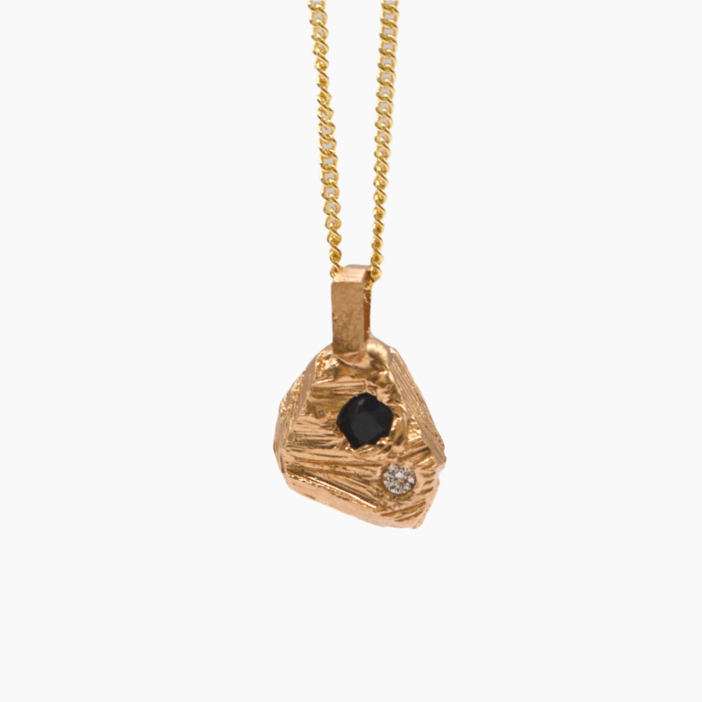 rock textured pendant set in yellow gold