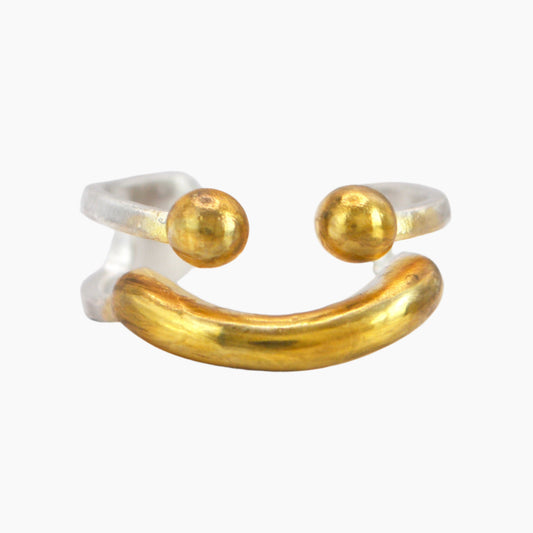 A happy face ring made from sterling silver and 14ct yellow gold.